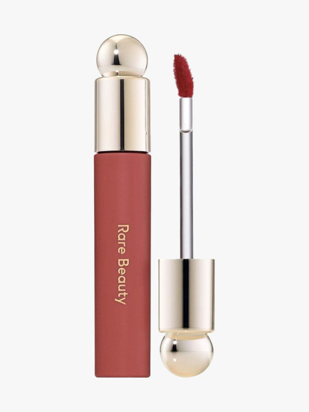 Rare Beauty Soft Pinch Tinted Lip Oil in Delight tube of red lip oil with gold cap on light gray background