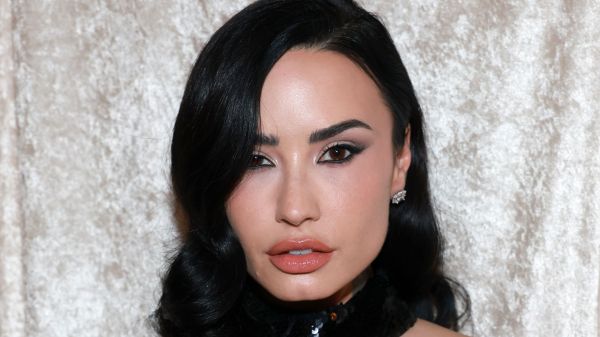 Demi Lovato appears at the Grammys in a black halter gown and black bob.